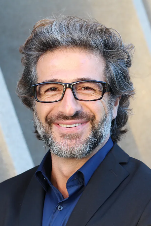 Andropause-and-Low-Testosterone-Treatment A man with glasses, salt and pepper hair and a beard smiling because he received treatment for andropause and low testosterone from Balanced Medical Solutions in San Francisco Bay Area.