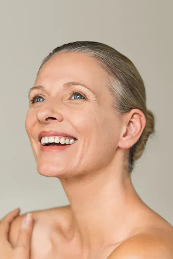 A middle-aged woman with smooth, beautiful skin. Get Biotin IV therapy from Balanced Medical Solutions in San Francisco Bay Area.