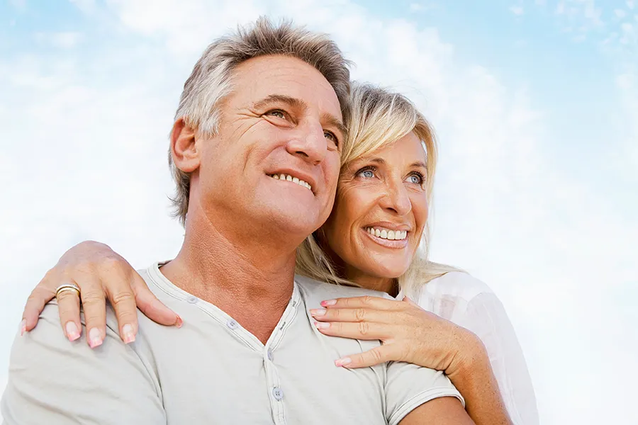 CJC-1295-Peptide-Clinic A mature couple embraces outside under the sky. Get CJC 1295 anti-aging peptides from Balanced Medical Solutions in San Francisco Bay Area.
