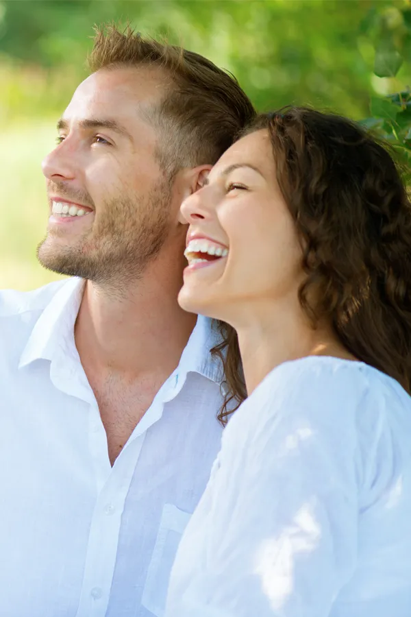 Immunotherapy-Treatment A couple in white clothes smiling outside. Get immune support treatment from Balanced Medical Solutions in San Francisco Bay Area.