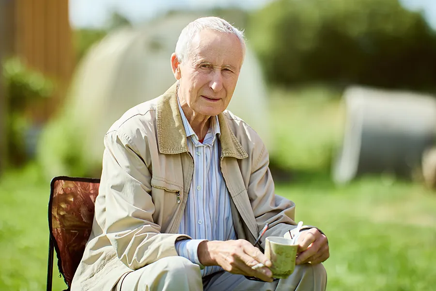 A very thin older man sits outside. Get treatment for muscle atrophy from Balanced Medical Solutions in San Francisco Bay Area.