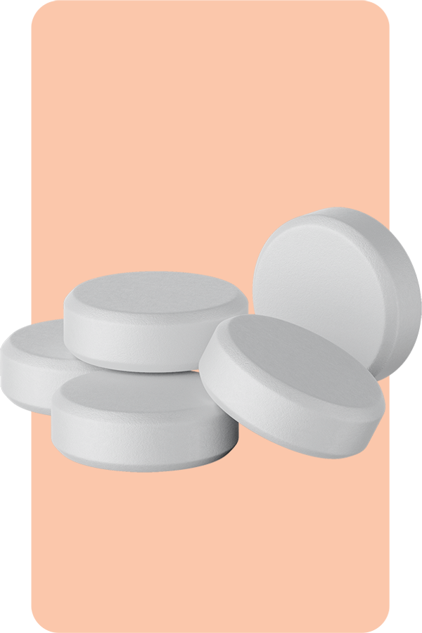 Oxytocin-for-Female-Sexual-Enhancement-Treatment Four white, circular tablets stacked slightly askew against a peach background representing Oxytocin for Female Sexual Enhancement treatment offered by Balanced Medical Solutions in San Francisco Bay Area.
