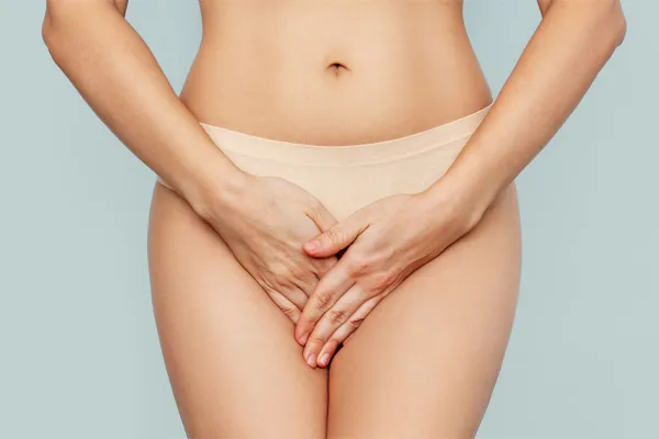 An image focusing on the midsection of a woman, holding her hands protectively over her lower abdomen representing PRP Vaginal Rejuvenation treatment offered by Balanced Medical Solutions in San Francisco Bay Area.