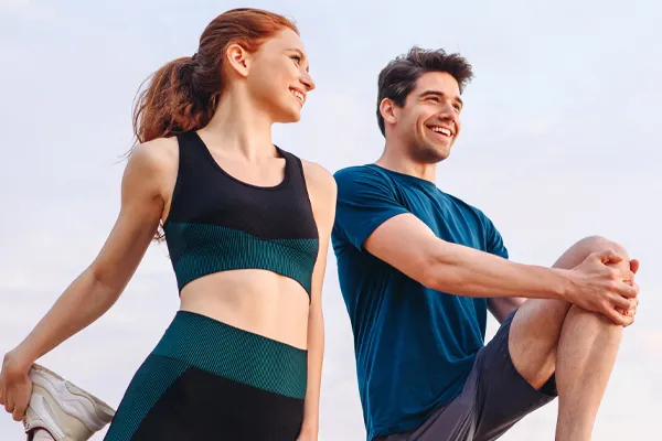 A couple stretch and get ready for a run. Schedule performance optimization treatment from Balanced Medical Solutions in San Francisco Bay Area.