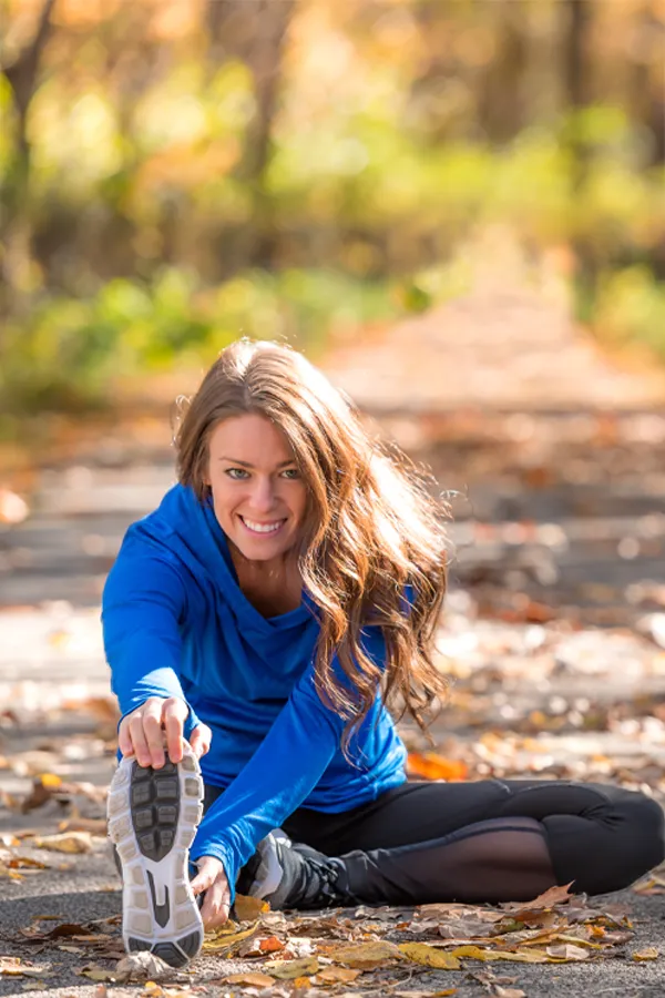 Sermorelin-Treatment A healthy woman in blue sweats stretches on a trail before a run. Get Sermorelin peptide therapy from Balanced Medical Solutions in San Francisco Bay Area.