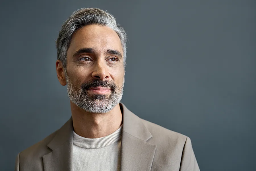 A handsome middle-aged man with salt-and-pepper hair and beard. Get testosterone boosters for men from Balanced Medical Solutions in San Francisco Bay Area.