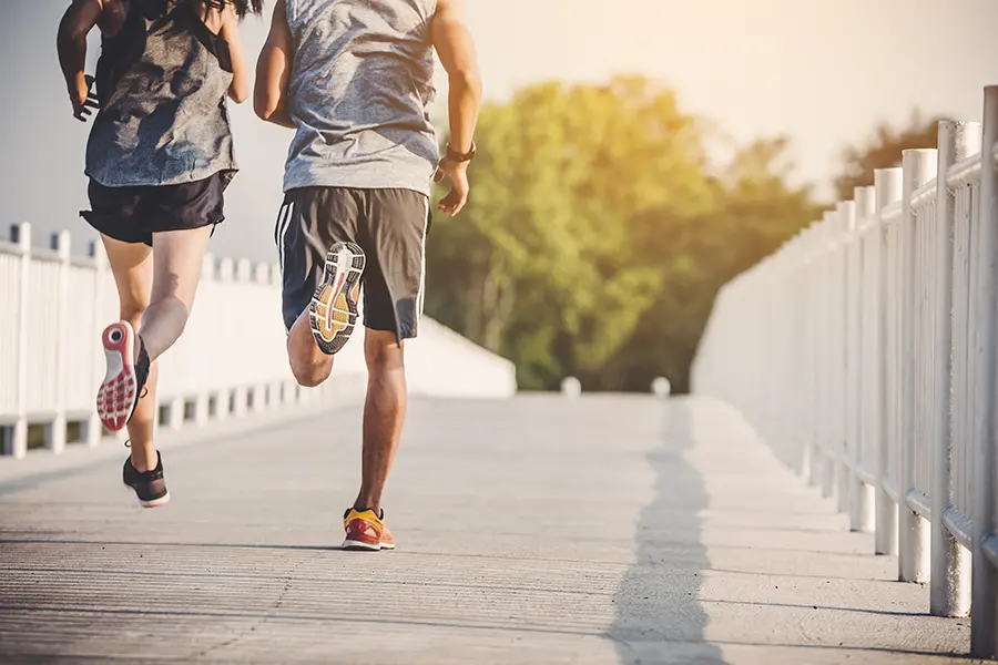 A couple runs across a bridge on a nice afternoon. Schedule Thymosin Beta 4 peptide therapy for immune function and weight loss from Balanced Medical Solutions in San Francisco Bay Area.