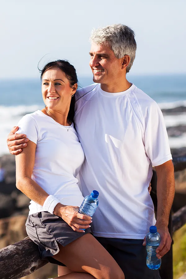 A middle-aged couple looks out over the beach after a run. Get organ regeneration stem cells and exosomes from Balanced Medical Solutions in San Francisco Bay Area.